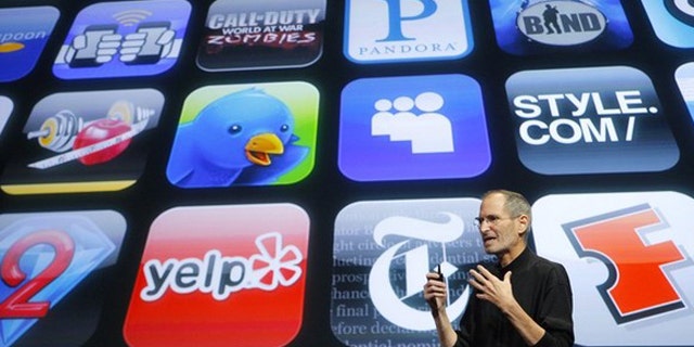 April 8, 2010: Apple Chief Executive Steve Jobs speaks in front of a display showing icons of various apps during the iPhone OS4 special event at Apple headquarters in Cupertino, Calif.