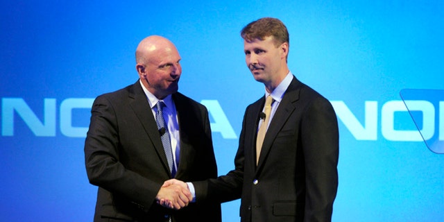 Microsoft CEO Steve Ballmer shakes hands with Nokia's Chairman of the Board Risto Siilasmaa (R) during the news conference of Finnish mobile phone manufacturer Nokia in Espoo, September 3, 2013.