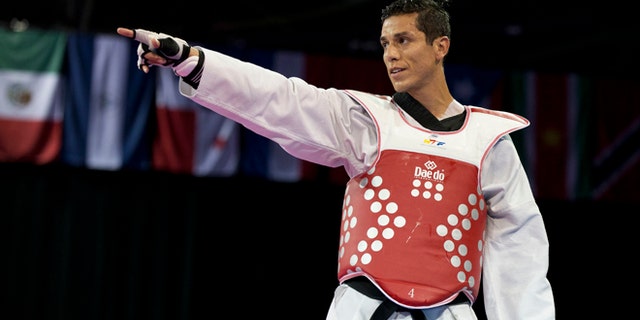 FILE - In this July 21, 2015 file photo, United States' Steven Lopez celebrates winning a bronze medal by defeating Venezuela's Javier Medina in the men's taekwondo under-80kg category at the Pan Am Games in Mississauga, Ontario. Lopez is competing on the Olympic stage for the fifth time, at the Summer Games in Rio de Janeiro, Brazil, where he's looking to add a medal to the ones he claimed in 2000, 2004 and 2008. (AP Photo/Rebecca Blackwell, File)
