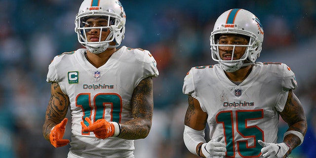 Miami Dolphins players Kenny Stills, left, and Albert Wilson took a knee during the national anthem before Sunday’s game against the New York Jets, continuing the protest Colin Kaepernick started.
