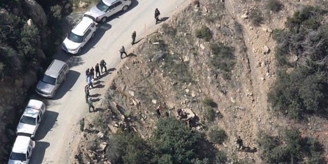 This aerial photo shows the scene of a shooting by a U.S. Border Patrol agent near San Diego on Tuesday, Feb. 18, 2014. Investigators say a man who was shot and killed by a U.S. Border Patrol agent near San Diego threw several large rocks at the agent, including one the size of a basketball. The San Diego County Sheriff's Department said Wednesday that the attacker began throwing fist-sized rocks at the agent from a hillside perch. The rocks got larger, and one of the bigger pieces hit the agent in the head. The sheriff's department says the agent fired his gun twice Tuesday, fearing that he might be killed or incapacitated if he was hit again. The agent was treated for minor injuries at a hospital and released. (AP Photo/U-T San Diego, John Gibbins) NO SALES; COMMERCIAL INTERNET OUT