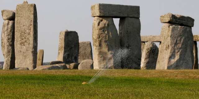 File photo - A sprinkler waters the grass surrounding the ancient site of Stonehenge, southern England April 30, 2011
