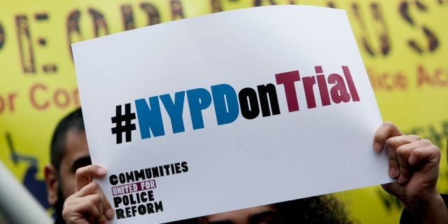 NEW YORK, NY - MARCH 18: A woman holds a sign during a demonstration against the city's "stop and frisk" searches in lower Manhattan near Federal Court March 18, 2013 in New York City. Hearings in a federal lawsuit filed by four black men against the city police department's "stop and frisk" searches starts today in Manhattan Federal Court. (Photo by Allison Joyce/Getty Images)