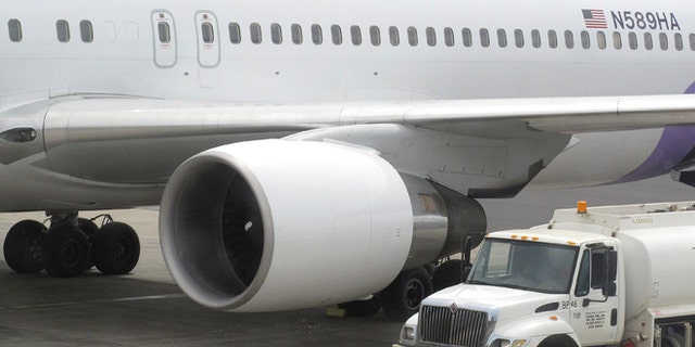 Hawaiian Airlines Flight 45 arrives from San Jose, Calif., in Kahului Airport in Kahului, Hawaii, on Monday, April 21, 2014. A 15-year-old boy on Sunday scrambled over an airport fence, crossed a tarmac and climbed into a jetliner's wheel well, then flew for five freezing hours to Hawaii on a misadventure that forced authorities to take a hard look at the security system that protects the nation's airline fleet. (AP Photo/Oskar Garcia)