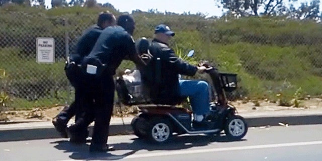 Video shows officers pushing disabled veteran after his scooter lost power.