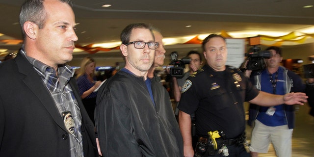 FILE - In a Oct. 15, 2014 file photo, Terry Speaks, center, a suspect in the 2012 stabbing and dismemberment of a Bourbon Street strip club dancer, arrives under heavy police guard at Louis Armstrong International Airport in Kenner, La. Trial is set to open Monday, June 15, 2015, for Speaks, accused of killing a New Orleans' French Quarter stripper in 2012, dismembering her and dumping body parts of the woman into the Gulf of Mexico. (Chris Granger/NOLA.com The Times-Picayune via AP, File) MAGS OUT; NO SALES; USA TODAY OUT; THE BATON ROUGE ADVOCATE OUT