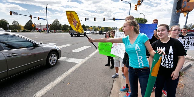 Sept. 23, 2014: Pamona High School students engage with passing motorists in a busy intersection near their school, during a multi-school protest against a Jefferson County School Board proposal to emphasize patriotism and downplay civil unrest in the teaching of U.S. history, in Arvada, Colo.