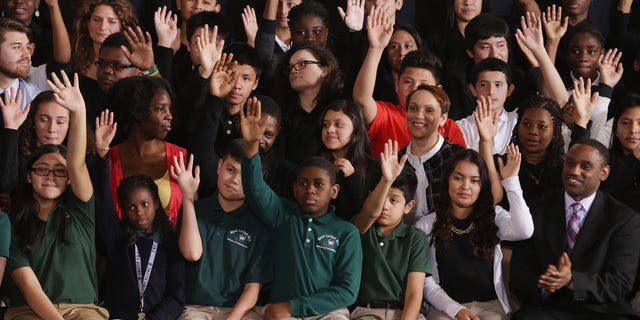 Students in Adelphi, Maryland, raise their hands when asked if they planned on going to college