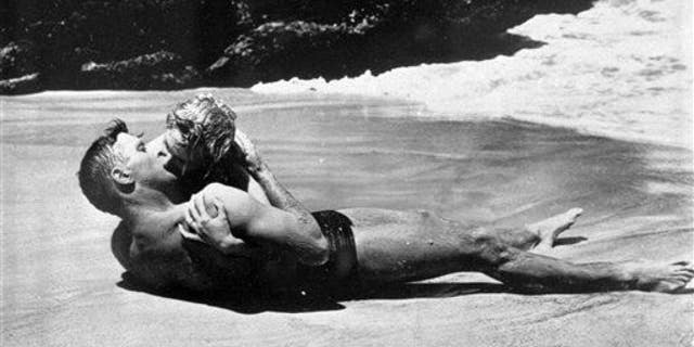 Burt Lancaster kisses Deborah Kerr passionately in a beach scene in the 1953 film "From Here To Eternity." The two shared one of cinema's most famous kisses .. and bacteria, most likely.