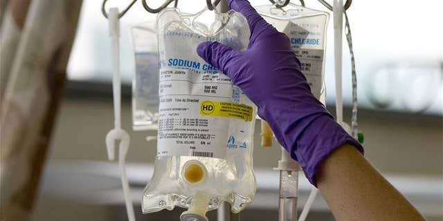 In this Aug. 4, 2015, file photo, a nurse places a patient's chemotherapy medication on an IV stand at a hospital in Philadelphia.