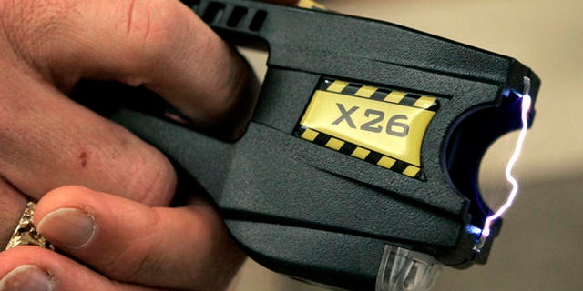 A Taser X26 stun gun is displayed at the Oakland Country Sheriff's office in Pontiac, Mich., Tuesday, Dec. 12, 2006. A little-noticed bill that would let more people use Tasers and stun guns in Michigan is awaiting Gov. Jennifer Granholm's signature, though critics hope she wields her veto pen. The legislation approved by the state Senate 30-7 last week would exempt detention facilities and private security officers at some hospitals and malls from a ban against Tasers, which have been criticized for causing deaths. (AP Photo/Carlos Osorio)