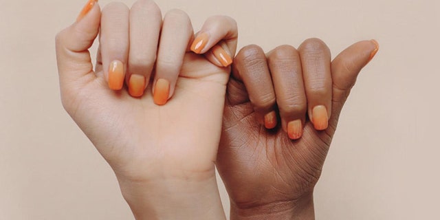 A South Korean beauty company has been accused of racism after posting an ad with a black hand and a white hand.