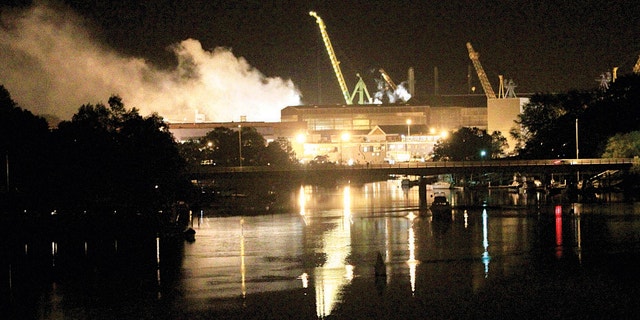 May 23, 2012: Smoke rises from a dry dock as fire crews respond Wednesday, to a fire on the USS Miami.