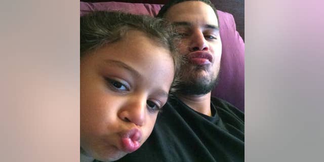 In this undated photo provided by Elizabeth Arroyo, construction worker Gilterto Drogheo sits with his young daughter, Gia, in New York. On March 10, 2010, Drogheo was shot and killed in New York by William Groomes, a 69-year-old retired jail guard licensed to carry a concealed weapon. Groomes claimed he was trying to arrest Drogheo for assault. (Gilterto Drogheo/Elizabeth Arroyo via AP)
