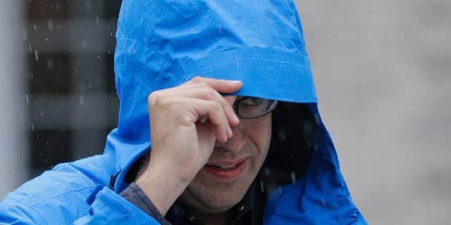 FILE - In this July 7, 2015, file photo, Subway restaurant spokesman Jared Fogle walks to a waiting car as he leaves his home in Zionsville, Ind. Fox 59 television station reported Tuesday, Aug. 18 that the Subway pitchman is expected to plead guilty to child-pornography charges, citing sources it did not identify. (AP Photo/Michael Conroy, File)