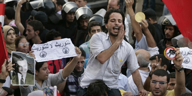 September 21: Egyptian activists shout anti - succession slogans during a protest in Cairo, Egypt. (AP)