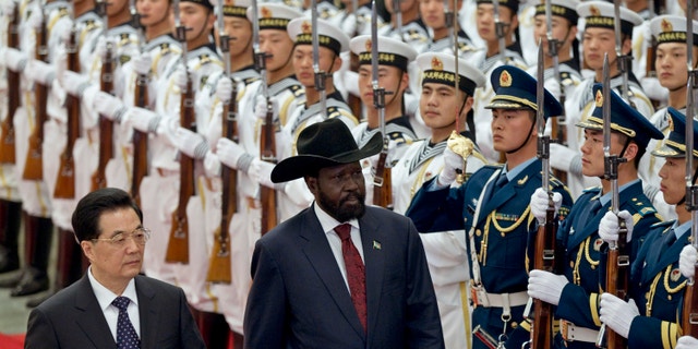 April 24, 2012: South Sudan's President Salva Kiir, right, reviews honor guard with Chinese President Hu Jintao, left, during a welcoming ceremony at the Great Hall of the People.