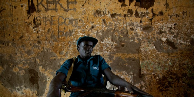 Jan. 9, 2011: A southern Sudanese police officer on security detail outside a polling station in the southern Sudanese capital of Juba. Women broke out in song and men wrapped themselves in flags as voters in Southern Sudan began casting ballots Sunday in a weeklong independence referendum likely to create the world's newest nation about five years after the end of a brutal civil war. The mainly Christian south is widely expected to secede from the mainly Muslim north, splitting Africa's largest country in two. (AP)