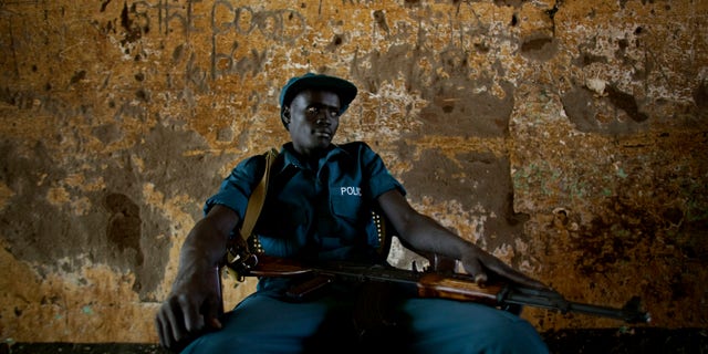 Jan. 9, 2011: A southern Sudanese police officer on security detail outside a polling station in the southern Sudanese capital of Juba. Women broke out in song and men wrapped themselves in flags as voters in Southern Sudan began casting ballots Sunday in a weeklong independence referendum likely to create the world's newest nation about five years after the end of a brutal civil war. The mainly Christian south is widely expected to secede from the mainly Muslim north, splitting Africa's largest country in two. (AP)