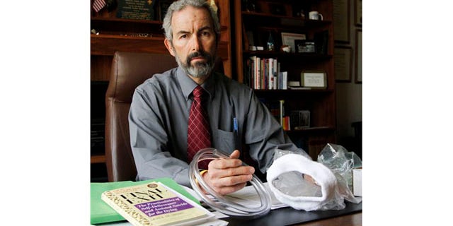 May 12: Oregon State Sen. Floyd Prozanski shows a suicide kit consisting of the book "Final Exit", plastic tubing and a plastic bag with collar that fits over a person's head at his Capitol office in Salem, Ore.