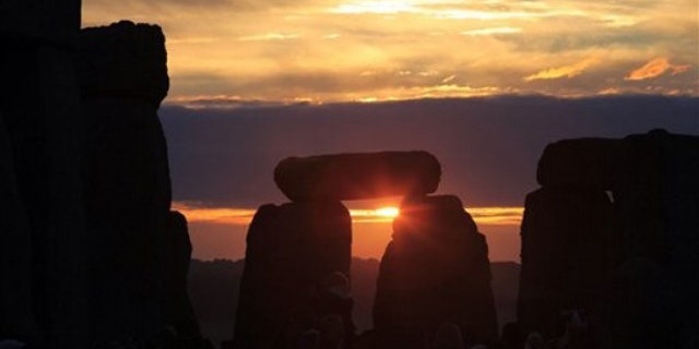 June 21, 2010: The sun rises behind the Stonehenge monument in England during the summer solstice, shortly after 4:52 am, early Monday.