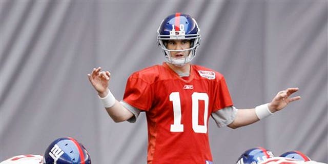 Feb. 3: New York Giants' Eli Manning (10) gives direction during practice in Indianapolis.