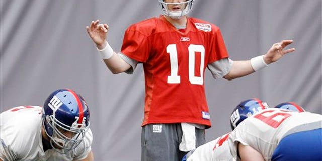 Feb. 3: New York Giants' Eli Manning (10) gives direction during practice in Indianapolis.