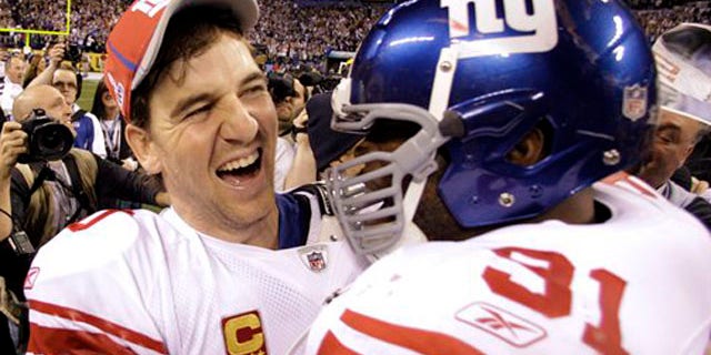 Feb. 5, 2012: New York Giants quarterback Eli Manning, left, and Aaron Ross celebrate their team's 21-17 win.