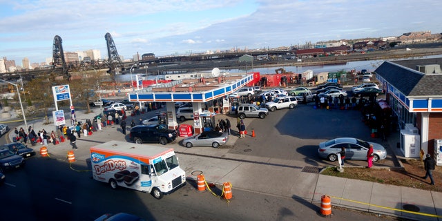 Nov. 2, 2012: People and vehicles line up at a gas station waiting to fill up in Newark, N.J.