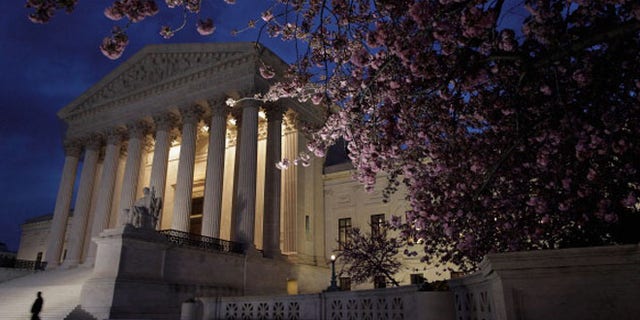 WASHINGTON, DC - MARCH 28: A security officer walks along the west front of the U.S. Supreme Court Building on March 28, 2012 in Washington, DC. Today is the last of three day the high court set to hear arguments over the constitutionality of the Patient Protection and Affordable Care Act. (Photo by Chip Somodevilla/Getty Images)