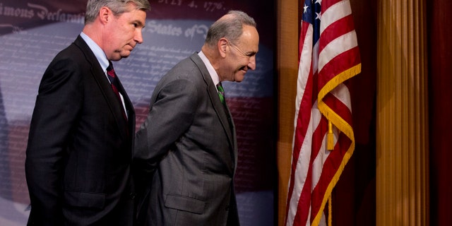 Sen. Charles Schumer and Sen. Sheldon Whitehouse leave a news conference on Capitol Hill, Wednesday, April 2, 2014.