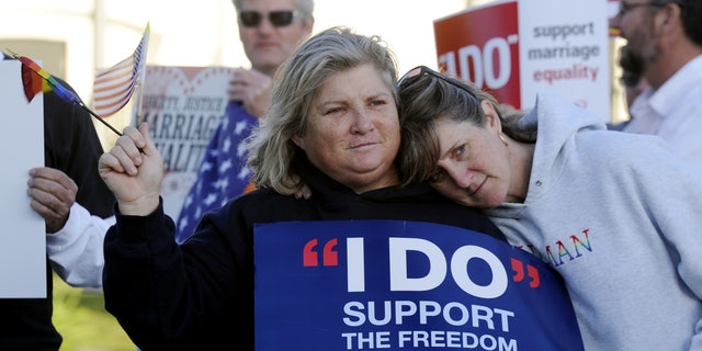 Kim Roberts, left, and her partner Lisa Mayes of Benicia, California, participate in a marriage equality rally on March 26, 2013, at the Solano County Government Center in Fairfield. (AP Photo/The Reporter, Joel Rosenbaum)