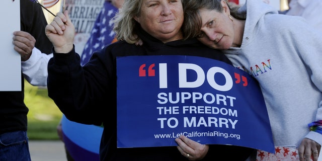 Kim Roberts, left, and her partner Lisa Mayes of Benicia, California, participate in a marriage equality rally on March 26, 2013, at the Solano County Government Center in Fairfield. (AP Photo/The Reporter, Joel Rosenbaum)