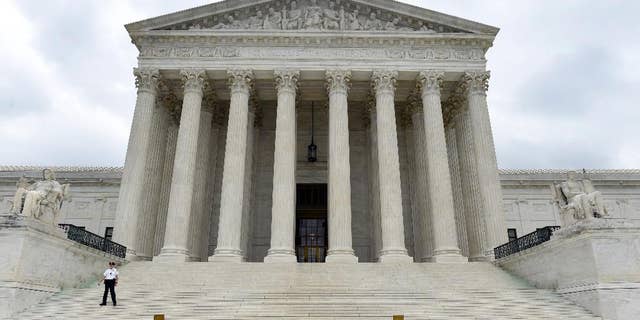 This photo taken Friday, Oct. 3, 2014, shows the U.S. Supreme Court in Washington. A Supreme Court term that is starting Monday, Oct. 6, 2014, with a lack of headline-grabbing cases may end with a blockbuster that helps define the legacy of the court under Chief Justice John Roberts. That's because the justices appear likely to take on the issue of same-sex marriage and decide once and for all whether gay and lesbian couples have a constitutional right to marry. (AP Photo/Susan Walsh)