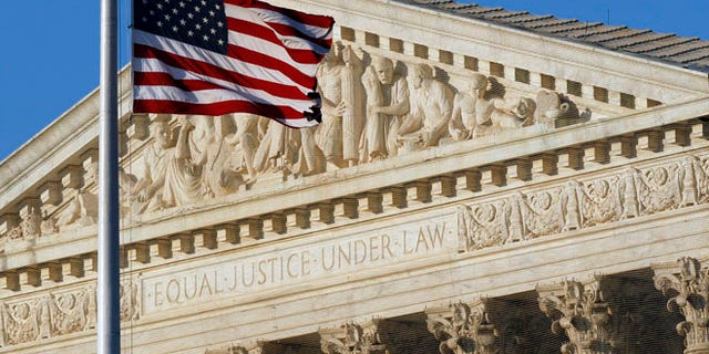 This June 27, 2012, file photo shows an American flag in front of the U.S. Supreme Court in Washington.