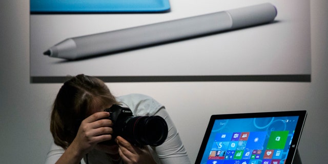 An attendee photographs the new Microsoft Surface Pro 3, during an event in New York May 20.