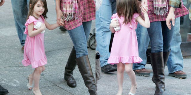 Suri Cruise is seen in high heels with her parents in October