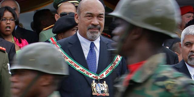 FILE - In this Aug. 12, 2010 file photo, Suriname's President Desi Bouterse attends a military parade after his swearing-in ceremony in Paramaribo, Suriname. On Tuesday, July 14, 2015, Suriname’s Parliament gave Bouterse a second term as the South American nation’s president. Bouterse is a two-time coup leader and former dictator. (AP Photo/Andres Leighton, File)
