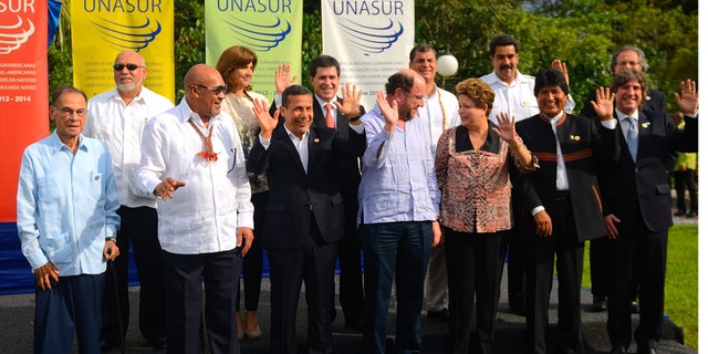 Heads of state and representatives of South American nations pose for the group photo at the VII Summit of the Union of South American Nations (UNASUR) in Paramaribo, Suriname, Friday, Aug. 30, 2013. Front row from left, UNASUR Secretary General Ali Rodriguez, Suriname's President Desi Bouterse, Peru's President Ollanta Humala, Chile's Foreign Minister Alfredo Moreno, Brazil's President Dilma Rousseff, Bolivia's President Evo Morales and Argentina's Vice-President Amado Boudou. Back row from left, Guyana's President Donald Ramotar, Colombia's Foreign Minister Maria Angela Holguin, Paraguay's President Horacio Cartes, Ecuador's President Rafael Correa, Venezuela's President Nicolas Maduro and Uruguay's Foreign Minister Luis Almagro. (AP Photo/Ertugrul Kilic)