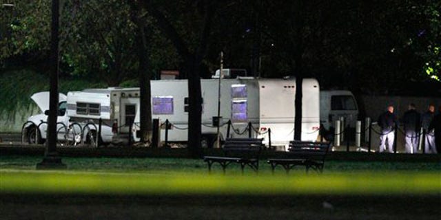 U.S. Park Police investigate a suspicious vehicle parked by the National Mall near the U.S. Capitol in Washington, on Wednesday, Nov. 3, 2010. U.S. Park Police say a man has been arrested after guns and ammunition were found inside a vehicle parked near the National Mall.
