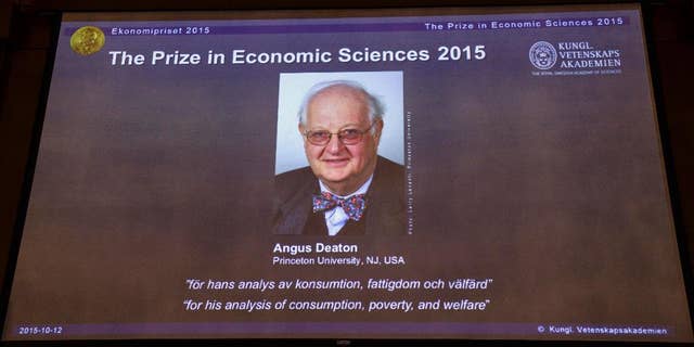 A view of the screen showing an image of Professor Angus Deaton, winner of the 2015 Sveriges Riksbank Prize in Economic Sciences in Memory of Alfred Nobel, as the Permanent Secretary for the Royal Swedish Academy of Sciences addresses a press conference to announce the winner of the prize, at the Royal Swedish Academy of Science, in Stockholm, Sweden, Monday, Oct. 12, 2015. Scottish economist Angus Deaton has won the Nobel memorial prize in economic sciences for "his analysis of consumption, poverty, and welfare," the Royal Swedish Academy of Sciences said Monday.  (Maja Suslin/TT News Agency via AP)