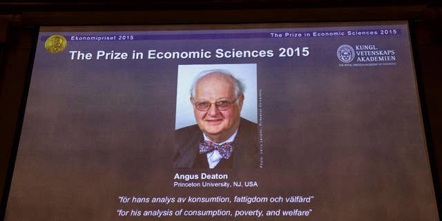 A view of the screen showing an image of Professor Angus Deaton, winner of the 2015 Sveriges Riksbank Prize in Economic Sciences in Memory of Alfred Nobel, as the Permanent Secretary for the Royal Swedish Academy of Sciences addresses a press conference to announce the winner of the prize, at the Royal Swedish Academy of Science, in Stockholm, Sweden, Monday, Oct. 12, 2015. Scottish economist Angus Deaton has won the Nobel memorial prize in economic sciences for "his analysis of consumption, poverty, and welfare," the Royal Swedish Academy of Sciences said Monday. (Maja Suslin/TT News Agency via AP)