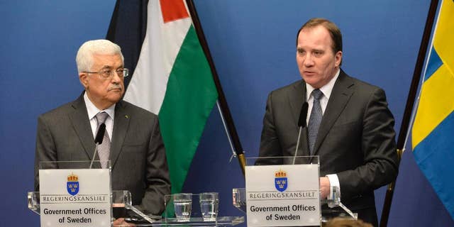 Palestinian President Mahmoud Abbas, left, and Sweden's Prime Minister Stefan Lofven during a press conference at the government headquarters Rosenbad in Stockholm, Sweden Tuesday, Feb. 10, 2015. President Abbas is on a one day official visit to Sweden. (AP Photo/TT/ Jonas Ekstromer ) SWEDEN OUT