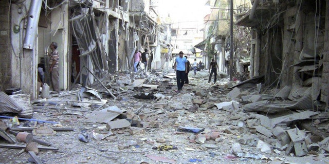 Aug. 8, 2012: This image made from amateur video released by the Shaam News Network purports to show the destruction of houses by shelling from Syrian government forces in Damascus.