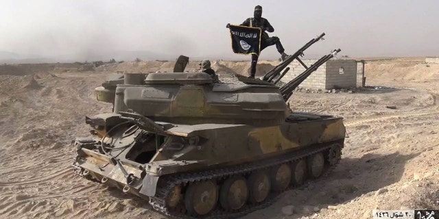Aug. 5, 2015 - ISIS militant on a tank captured from Syrian government forces, in the town of Qaryatain southwest of Palmyra, central Syria. ISIS has abducted 230 residents, including dozens of Christians, from a central Syrian town captured by the extremists the day before, activists said Friday.