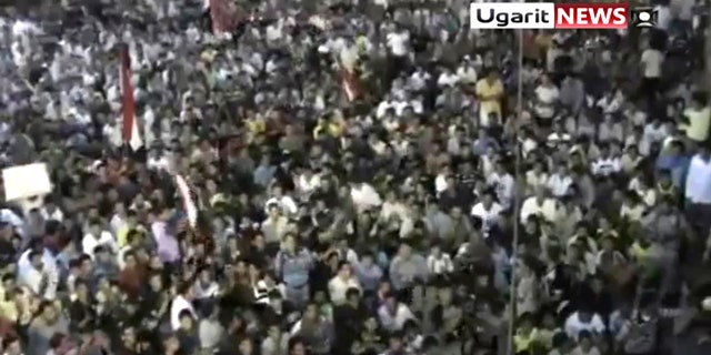 Aug. 18: In this image from amateur video by the Ugarit News group, a large crowd reportedly gathered in the town of Rastan near Homs on Wed., Aug 17, during which people chanted "Rastan demands the execution of the president."