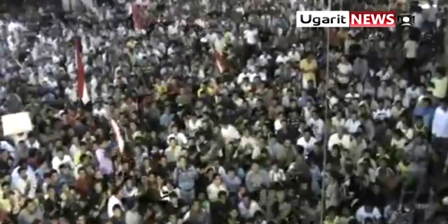 Aug. 18: In this image from amateur video by the Ugarit News group, a large crowd reportedly gathered in the town of Rastan near Homs on Wed., Aug 17, during which people chanted "Rastan demands the execution of the president."