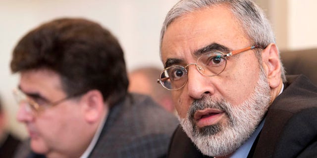 April 23, 2013: In this file photo, Syrian Information Minister Omran al-Zoubi, right, speaks during his visit to the Russian parliament's lower house in Moscow. The Syrian government wants more details before deciding whether to take part in a proposed U.S.-Russian initiative to negotiate a peaceful end to Syria's crisis, the country's information minister said Tuesday, May 14, 2013.