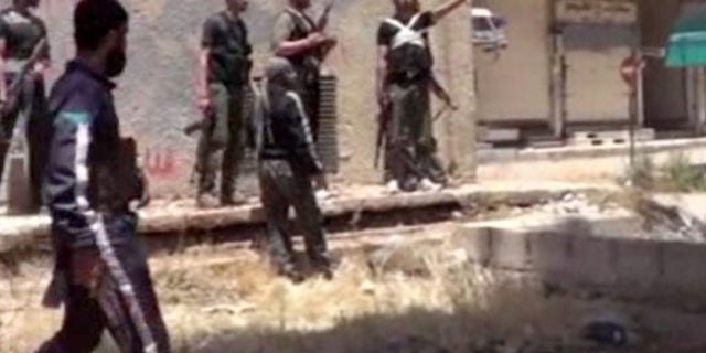 May 28, 2013: This image from amateur video obtained by a group which calls itself Ugarit News, which is consistent with AP reporting, shows rebel fighters in Daraa, Syria. Europe's decision to allow member states to arm Syrian rebels and Russia's renewed pledge to send advanced missiles to the Syria regime could spur an arms race in an already brutal civil war and increasingly turn it into a East-West proxy fight.