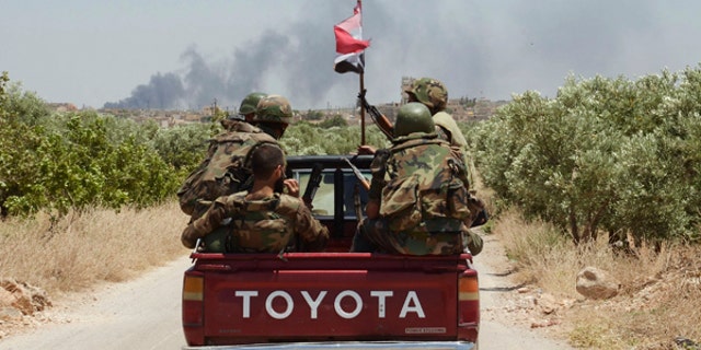 June 15, 2013: Forces loyal to Syria's President Bashar al-Assad are seen in Ain-Assan village during what they said was an operation to occupy it, in southern countryside of Aleppo.